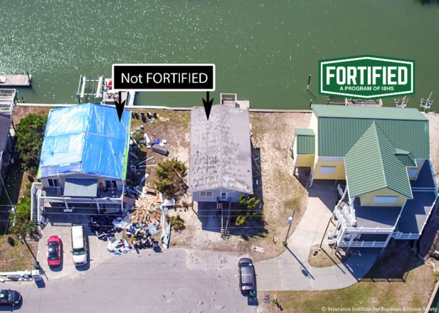 Aerial view of two houses side by side, one labeled 'Not FORTIFIED' with a blue tarp on the roof and debris around it, and the other labeled 'FORTIFIED' with a green roof, showing structural reinforcement differences.