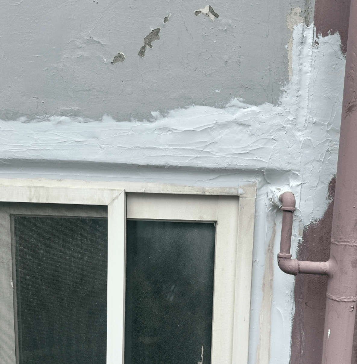 창문 주변에 방수 처리가 된 모습으로, 벽면과 창틀의 이음새에서 방수재가 적용된 상황을 보여줍니다.